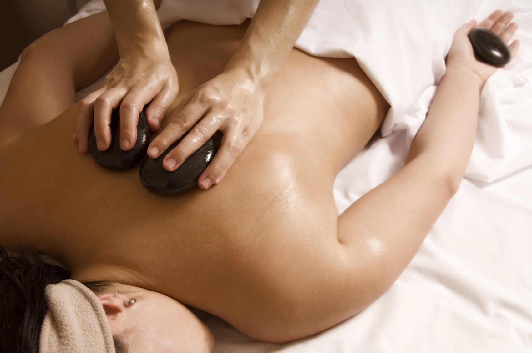 Warm Up With A Hot Stone Massage Transcend Massage And Wellness Spa