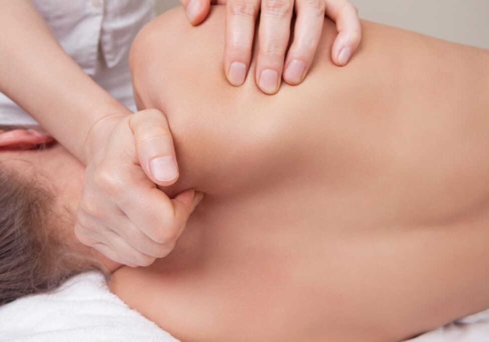 Professional  therapist doing neck and shoulder deep tissue and sport massage